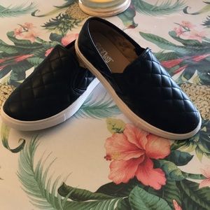 Black quilted leather slip on loafer style shoes